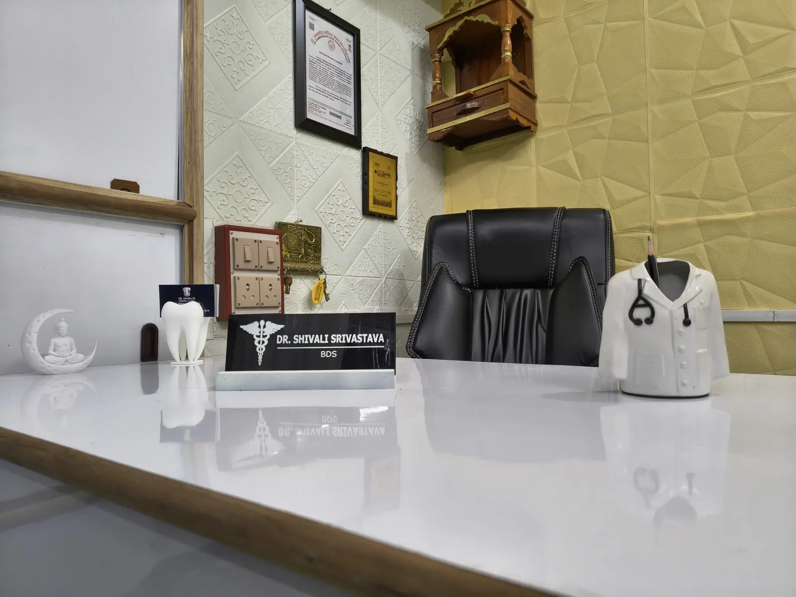 Doctor's cabin and consultation desk with the Dr. Shivali Srivastava BDS nameplate at the dental clinic in Varanasi